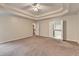 Spacious bedroom featuring trey ceiling, carpet, and ensuite bathroom access at 2280 Copper Trail Ln, Buford, GA 30519