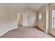 Bedroom with neutral walls and carpet, showing one regular and one round window at 2280 Copper Trail Ln, Buford, GA 30519