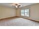 Cozy bedroom featuring neutral walls, carpet, a ceiling fan, and a bright window at 2280 Copper Trail Ln, Buford, GA 30519