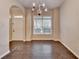 Dining room area with hardwood floors, a chandelier, and a window letting in natural light at 2280 Copper Trail Ln, Buford, GA 30519