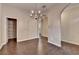 Dining area with hardwood floors, a pantry closet, a chandelier, and arched doorways at 2280 Copper Trail Ln, Buford, GA 30519