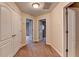 Hallway features neutral walls, carpet, white trim, and doors leading to various rooms at 2280 Copper Trail Ln, Buford, GA 30519