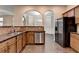 Open concept kitchen features granite countertops, stainless steel appliances, and breakfast bar seating at 2280 Copper Trail Ln, Buford, GA 30519