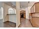 Spacious kitchen boasts hardwood floors, dark cabinetry, tiled backsplash and flows into dining area at 2280 Copper Trail Ln, Buford, GA 30519