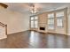 Spacious living room with hardwood floors, a fireplace, a ceiling fan, and ample natural light at 2280 Copper Trail Ln, Buford, GA 30519