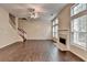 Bright living room features a fireplace, a staircase, hardwood floors, and large windows at 2280 Copper Trail Ln, Buford, GA 30519