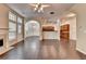 Open-concept living room with hardwood floors and neutral walls, next to kitchen at 2280 Copper Trail Ln, Buford, GA 30519