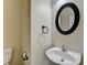 Cozy half-bathroom features a pedestal sink, and a decorative oval mirror at 2280 Copper Trail Ln, Buford, GA 30519