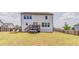Expansive backyard with a deck, lush green lawn, and a charming swing, ideal for outdoor enjoyment at 28 Rolling Rock Way, Dallas, GA 30157