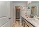 Bright bathroom featuring a double sink vanity and a shower/tub with gray curtain at 28 Rolling Rock Way, Dallas, GA 30157