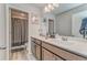 Bright bathroom featuring a double sink vanity and a shower/tub with gray curtain at 28 Rolling Rock Way, Dallas, GA 30157
