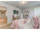 Charming bedroom with a desk, TV, and a comfortable bed with floral decorations at 28 Rolling Rock Way, Dallas, GA 30157