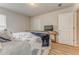 Comfortable bedroom featuring wood floors, a TV, and neutral colored walls at 28 Rolling Rock Way, Dallas, GA 30157