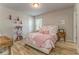 Bright bedroom with a desk, nightstand, and a comfortable bed with floral decorations at 28 Rolling Rock Way, Dallas, GA 30157