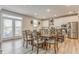 Dining area with large windows, wooden table and chairs, and kitchen access at 28 Rolling Rock Way, Dallas, GA 30157