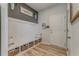 A stylish entryway with built-in bench, storage baskets, board and batten wall, and a 'gather' sign at 28 Rolling Rock Way, Dallas, GA 30157