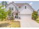 Charming two-story home with a manicured lawn, two-car garage, and beautiful curb appeal at 28 Rolling Rock Way, Dallas, GA 30157