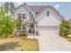 Charming two-story home with white siding, a well-manicured lawn, and a welcoming front entrance at 28 Rolling Rock Way, Dallas, GA 30157