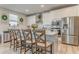 Kitchen island with seating, stainless appliances, and white cabinets at 28 Rolling Rock Way, Dallas, GA 30157