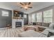 Cozy living room with a fireplace, large sectional sofa, and plenty of natural light from large windows at 28 Rolling Rock Way, Dallas, GA 30157