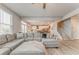 Spacious living room with a large sectional sofa, flowing into kitchen and staircase at 28 Rolling Rock Way, Dallas, GA 30157