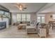 Bright living room with fireplace, large sectional, and view of dining area at 28 Rolling Rock Way, Dallas, GA 30157