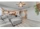 Bright open-concept living room with large sectional sofa and kitchen access at 28 Rolling Rock Way, Dallas, GA 30157