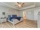 Bright and airy main bedroom featuring tray ceilings, wood-look floors, and a sitting area at 28 Rolling Rock Way, Dallas, GA 30157
