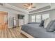 Light-filled main bedroom with wood-look floors, tray ceilings, and access to the bathroom at 28 Rolling Rock Way, Dallas, GA 30157
