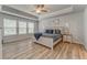 Spacious main bedroom boasts tray ceilings, wood-look floors, and large windows at 28 Rolling Rock Way, Dallas, GA 30157