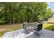 Relaxing backyard featuring a patio with outdoor furniture and views of a lush green forest at 3652 Morning Creek Ct, Suwanee, GA 30024