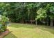 Large backyard with lush greenery and mature trees, creating a private and serene outdoor space at 3652 Morning Creek Ct, Suwanee, GA 30024