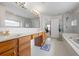 Luxurious bathroom with dual vanities, a soaking tub, separate shower, and access to the main bedroom at 3652 Morning Creek Ct, Suwanee, GA 30024
