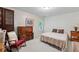 Cozy bedroom with light carpet, rocking chair, accent furniture and ample natural light at 3652 Morning Creek Ct, Suwanee, GA 30024