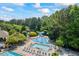 Large community pool with a separate splash pad area, lounge chairs, and tables with umbrellas at 3652 Morning Creek Ct, Suwanee, GA 30024
