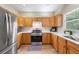 Well-lit kitchen featuring stainless steel appliances and light wood cabinets at 3652 Morning Creek Ct, Suwanee, GA 30024