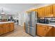 Spacious kitchen with a stainless steel refrigerator and a view into the living area at 3652 Morning Creek Ct, Suwanee, GA 30024