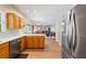 Modern kitchen with stainless steel appliances, wood cabinets, quartz counters, and open view to the cozy living area at 3652 Morning Creek Ct, Suwanee, GA 30024