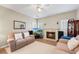 Comfortable living room with hardwood floors, a cozy fireplace, and a large television for entertainment at 3652 Morning Creek Ct, Suwanee, GA 30024