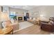 Inviting living room featuring a cozy fireplace, hardwood floors, and comfortable seating, perfect for relaxation at 3652 Morning Creek Ct, Suwanee, GA 30024