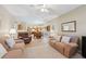 Spacious living room with a view of the open-concept kitchen and dining area, featuring hardwood floors at 3652 Morning Creek Ct, Suwanee, GA 30024