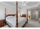 Large main bedroom featuring tray ceilings, carpet, a four poster bed, and an ensuite bath at 3652 Morning Creek Ct, Suwanee, GA 30024