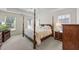 Bright main bedroom with a traditional bed, matching dresser and nightstand, and neutral carpet at 3652 Morning Creek Ct, Suwanee, GA 30024