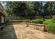 Spacious backyard patio with stone retaining wall, manicured hedges and lighting create an entertainment space at 583 Etowah Ne Dr, Marietta, GA 30060