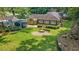 Large backyard with mature trees, lush green lawn, firepit, storage shed and fence create a private oasis at 583 Etowah Ne Dr, Marietta, GA 30060