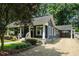 Charming home with a covered front porch, gravel driveway and lush landscaping creates a welcoming curb appeal at 583 Etowah Ne Dr, Marietta, GA 30060