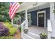 Inviting front porch with comfortable seating, potted plants, and view of the manicured landscaping at 583 Etowah Ne Dr, Marietta, GA 30060