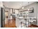 Modern kitchen boasts stainless steel appliances, granite countertops, an island with bar seating, and hardwood floors at 583 Etowah Ne Dr, Marietta, GA 30060