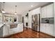 Spacious kitchen with a granite island, stainless steel appliances, white cabinets, and an open layout to the living area at 583 Etowah Ne Dr, Marietta, GA 30060