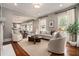 Bright living room featuring hardwood floors, neutral walls, fireplace, large windows, and open to the eat-in kitchen at 583 Etowah Ne Dr, Marietta, GA 30060